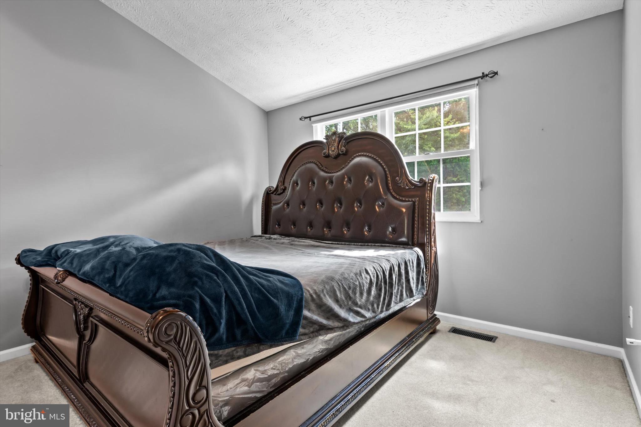 10462 Brackets Ford Circle Manassas, VA 20110 - Photo 14 of 39 a bedroom with a bed and a window
