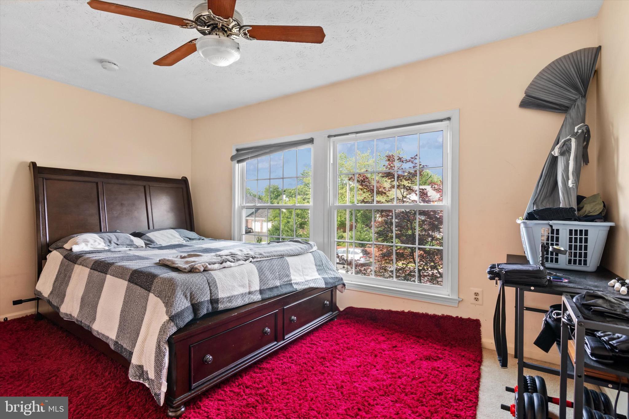 10462 Brackets Ford Circle Manassas, VA 20110 - Photo 23 of 39 a bed sitting in a bedroom next to a window