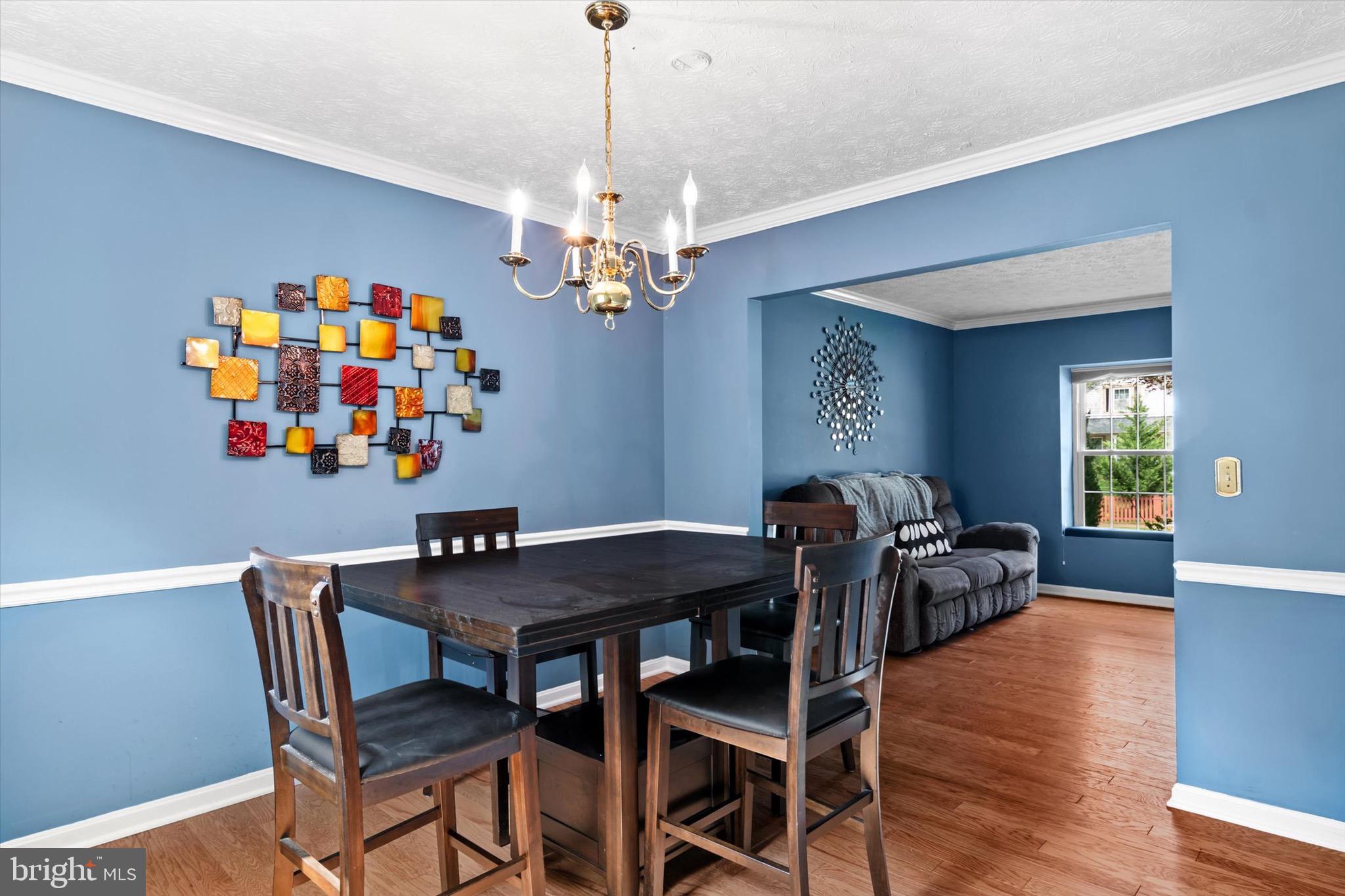 10462 Brackets Ford Circle Manassas, VA 20110 - Photo 8 of 39 a view of a dining room with furniture and wooden floor
