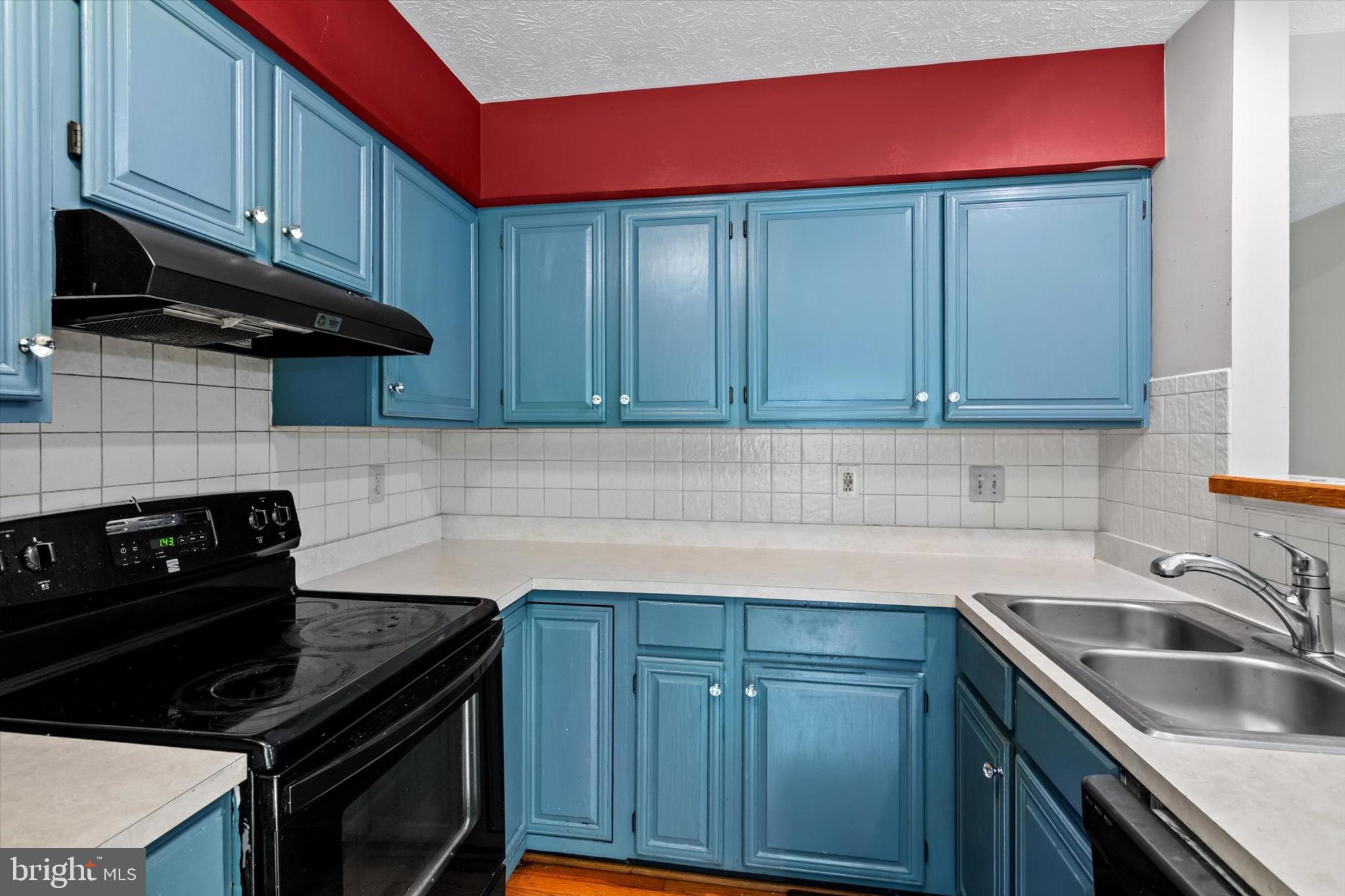 10462 Brackets Ford Circle Manassas, VA 20110 - Photo 9 of 39 a kitchen with granite countertop a stove top oven cabinetry a sink and dishwasher