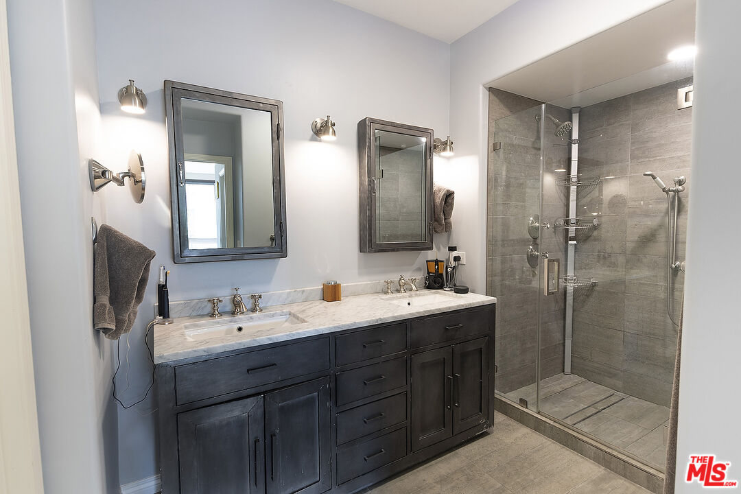 13044 Pacific Promenade, Unit 419 Playa Vista, CA 90094 - Photo 12 of 19 a bathroom with a double vanity sink mirror double shower and a mirror