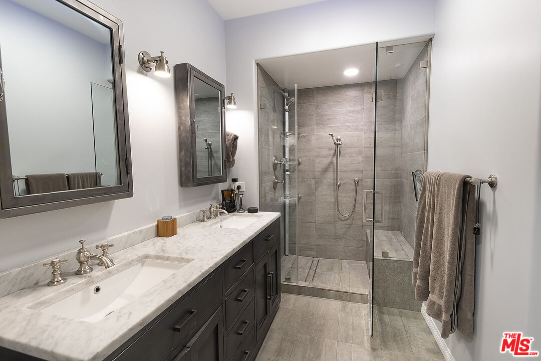 13044 Pacific Promenade, Unit 419 Playa Vista, CA 90094 - Photo 13 of 19 a bathroom with a double vanity sink mirror and shower