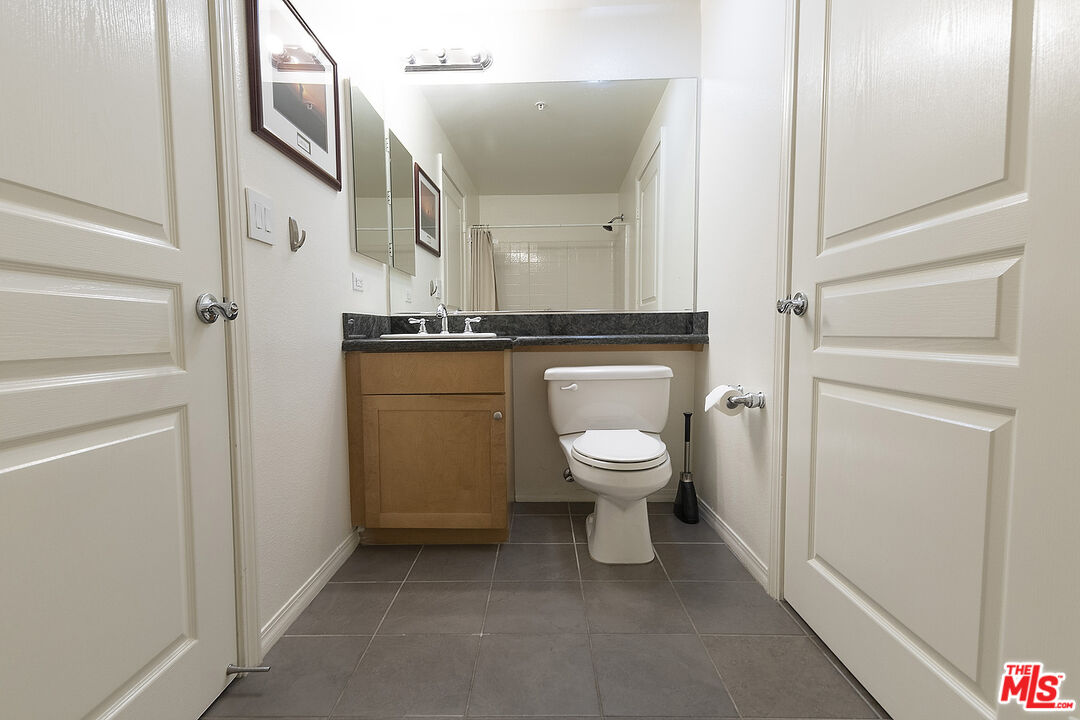 13044 Pacific Promenade, Unit 419 Playa Vista, CA 90094 - Photo 15 of 19 a bathroom with a toilet sink and mirror