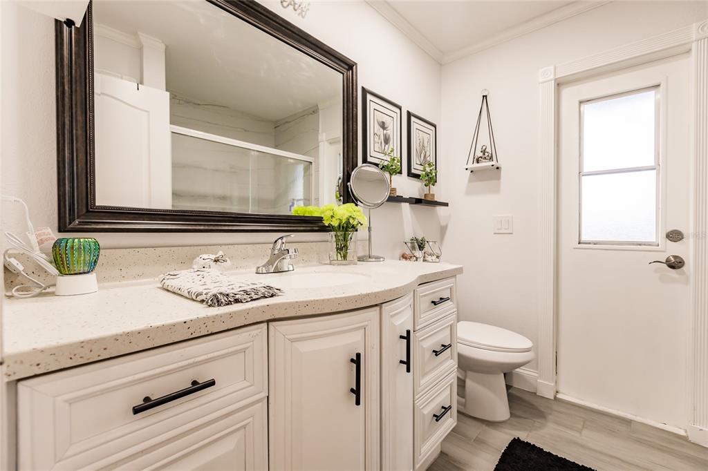 301 Gold Tree Punta Gorda, FL 33955 - Photo 31 of 60 a bathroom with a granite countertop toilet sink and mirror