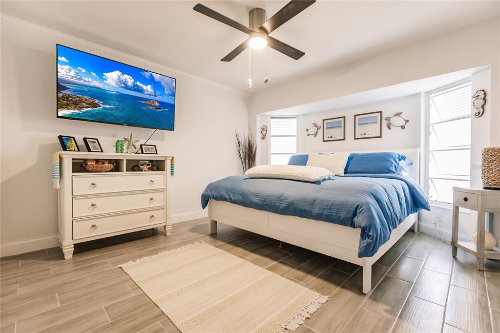 301 Gold Tree Punta Gorda, FL 33955 - Photo 33 of 60 a bedroom with a bed and a flat screen tv