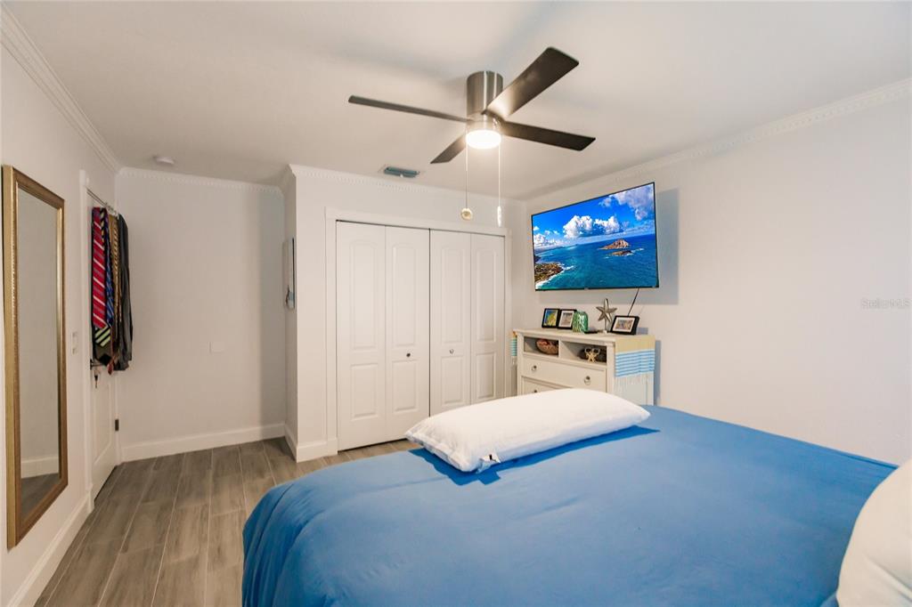 301 Gold Tree Punta Gorda, FL 33955 - Photo 35 of 60 a bedroom with a bed and a flat screen tv