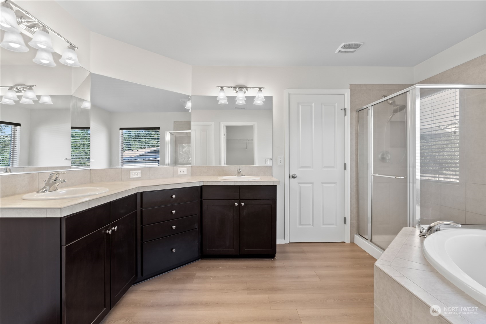 7004 Raptor Avenue Northeast Olympia, WA 98516 - Photo 13 of 28 a spacious bathroom with a double vanity sink a large mirror and a bathtub