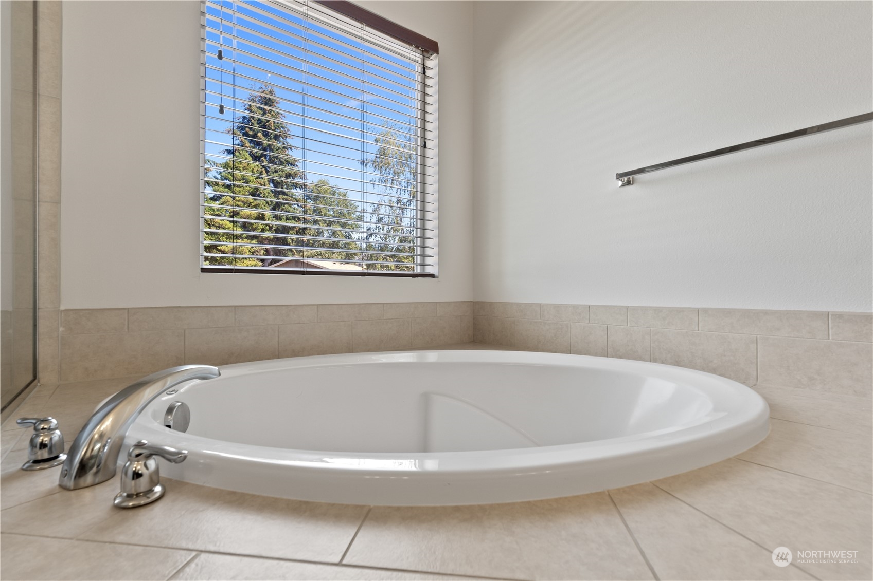 7004 Raptor Avenue Northeast Olympia, WA 98516 - Photo 14 of 28 a white bath tub sitting in a bathroom next to a window