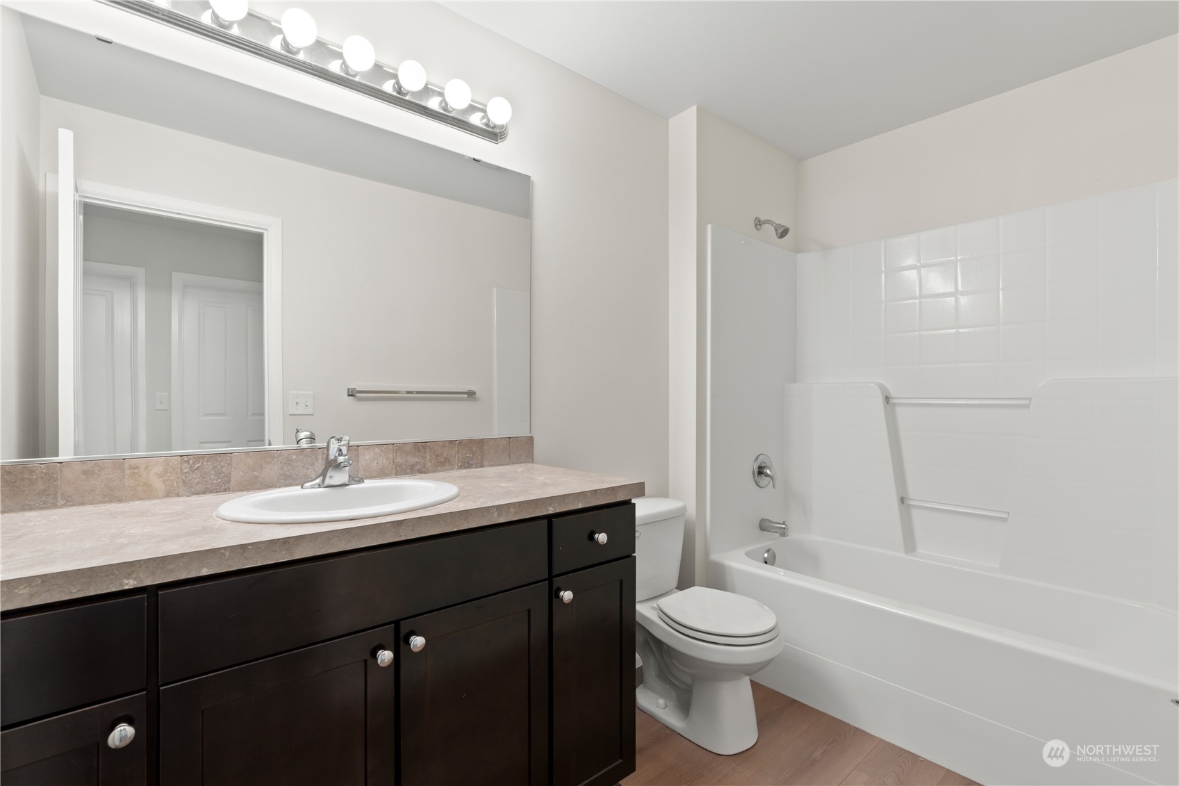 7004 Raptor Avenue Northeast Olympia, WA 98516 - Photo 20 of 28 a bathroom with a granite countertop sink a toilet and shower