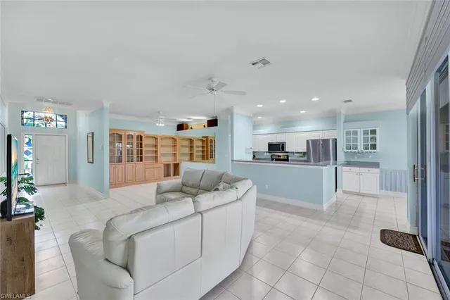 a living room with furniture and kitchen view