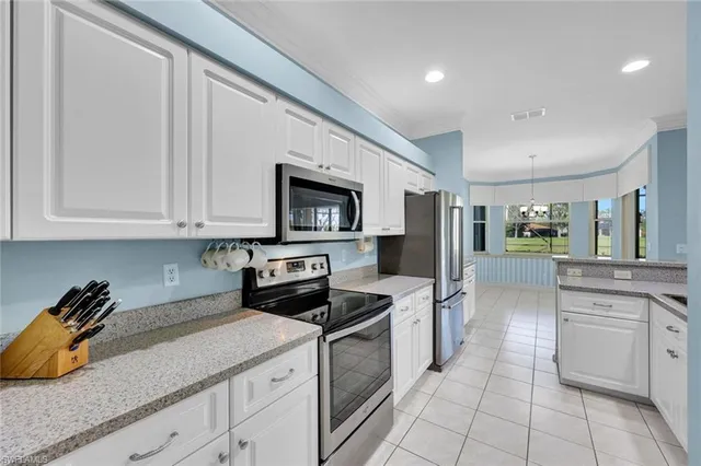 a kitchen with stainless steel appliances granite countertop a sink and cabinets