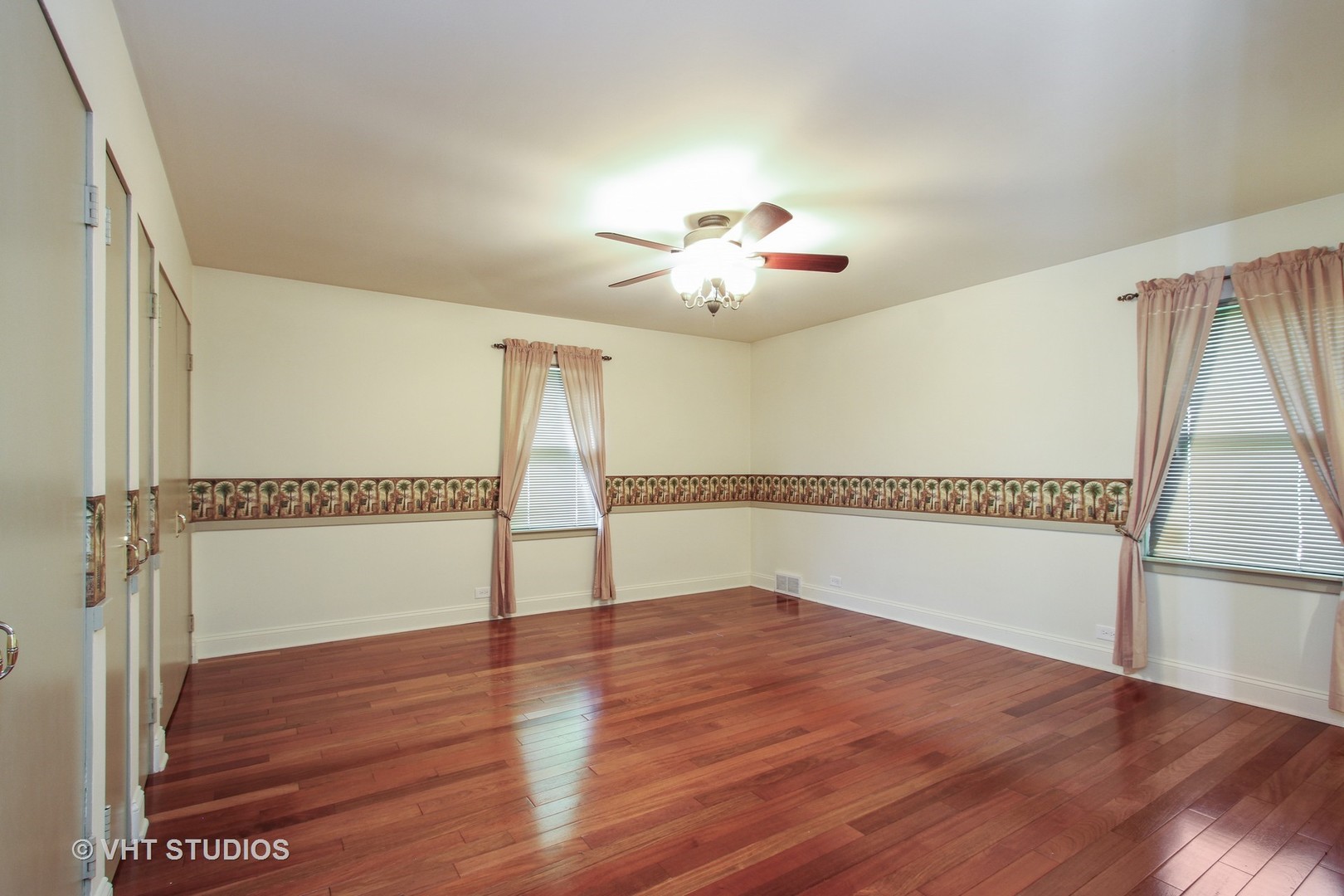 254 Spring Street Cary, IL 60013 - Photo 4 of 12 a view of an empty room with wooden floor and a window