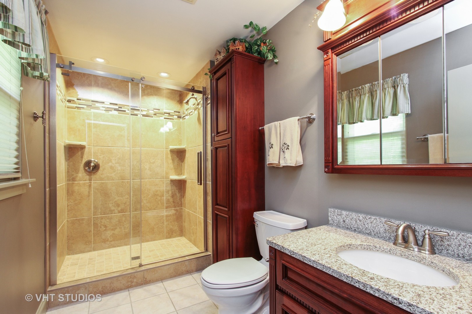 254 Spring Street Cary, IL 60013 - Photo 5 of 12 a bathroom with a granite countertop sink toilet and shower