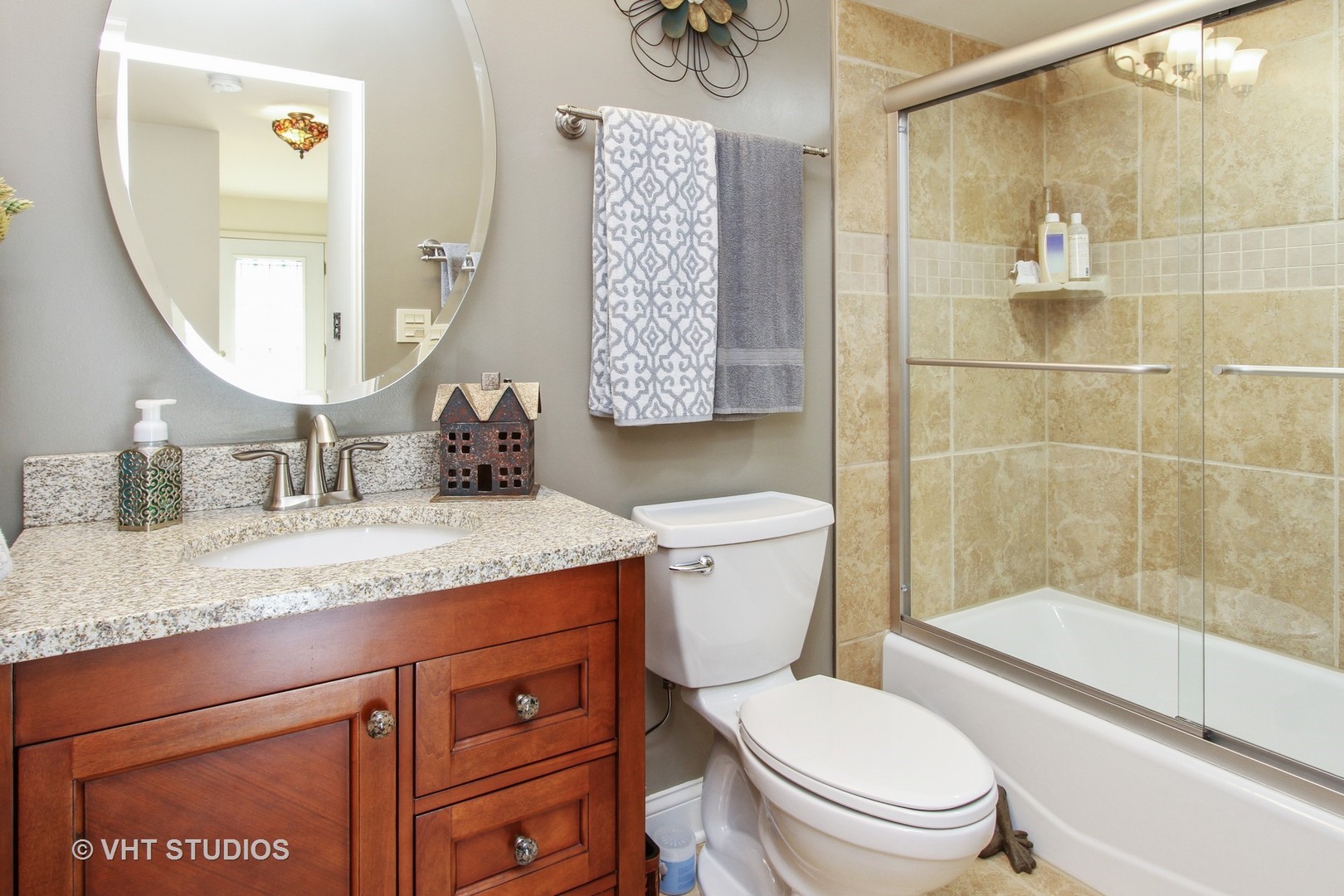 254 Spring Street Cary, IL 60013 - Photo 7 of 12 a bathroom with a granite countertop sink toilet and shower