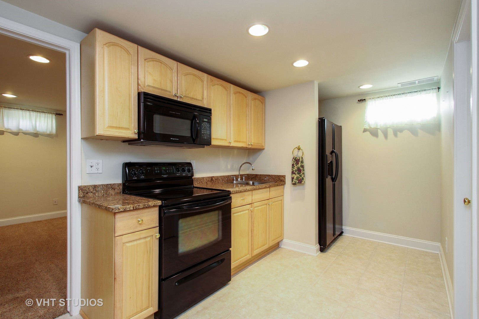 254 Spring Street Cary, IL 60013 - Photo 10 of 12 a kitchen with stainless steel appliances granite countertop a stove a refrigerator and a microwave