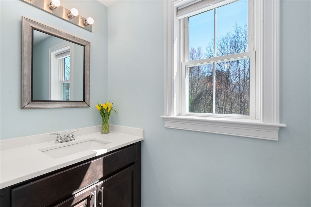 5 Glebe Street Rehoboth, MA 02769 - Photo 13 of 42 a bathroom with a sink a vanity and a mirror