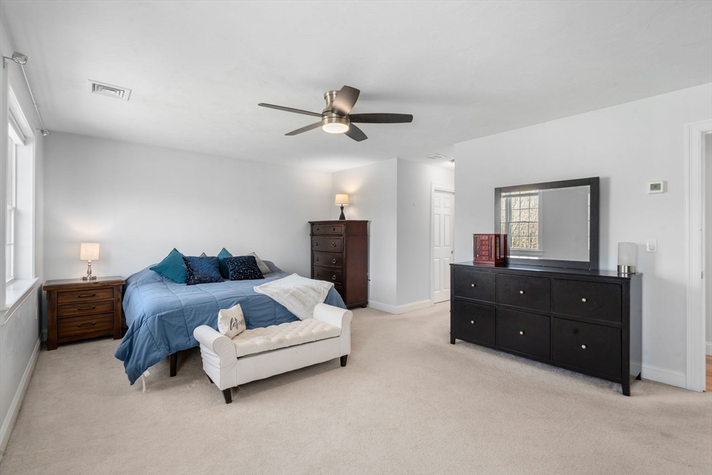 5 Glebe Street Rehoboth, MA 02769 - Photo 16 of 42 a spacious bedroom with a bed and a mirror on dresser