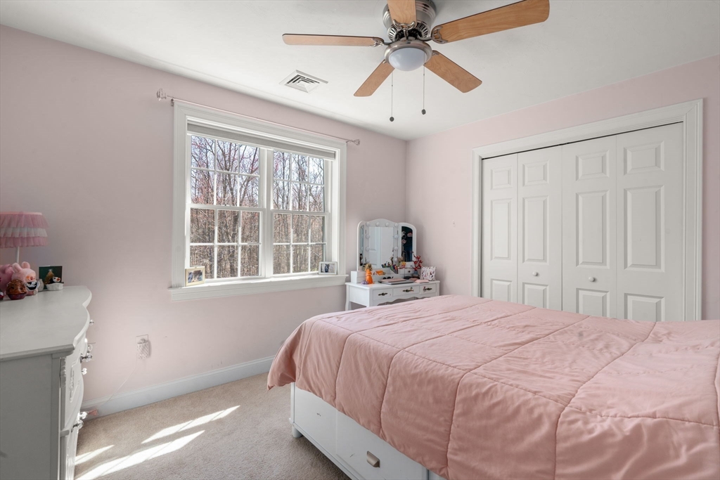 5 Glebe Street Rehoboth, MA 02769 - Photo 21 of 42 a bedroom with a large bed and a chandelier