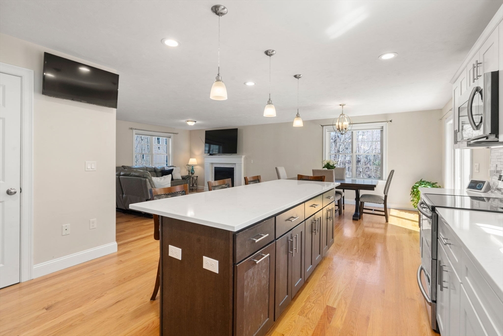 5 Glebe Street Rehoboth, MA 02769 - Photo 9 of 42 a large kitchen with kitchen island a sink a counter space and stainless steel appliances