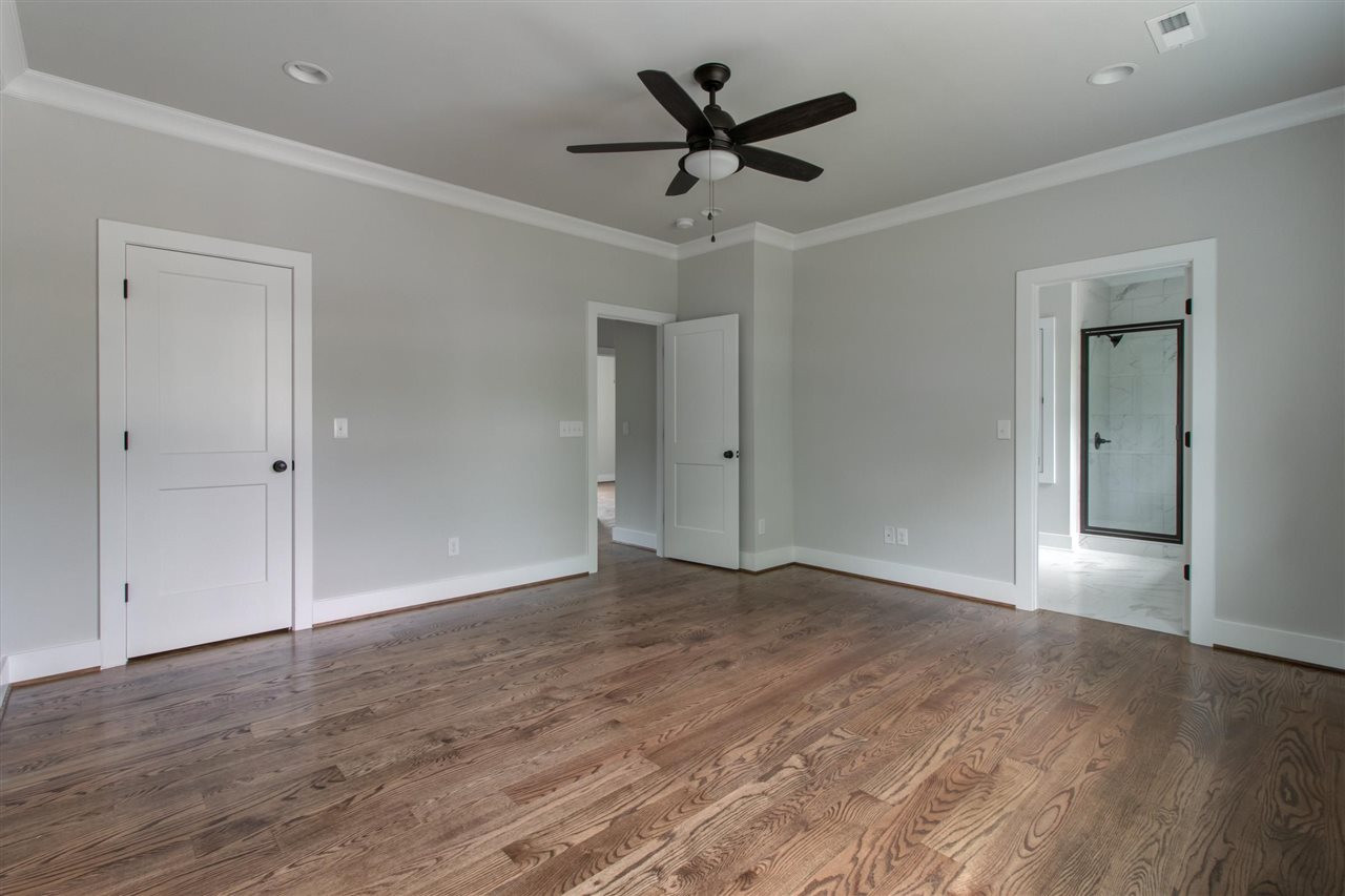 2929 Chapel Hill Road Durham, NC 27707 - Photo 12 of 25 an empty room with wooden floor and ceiling fan