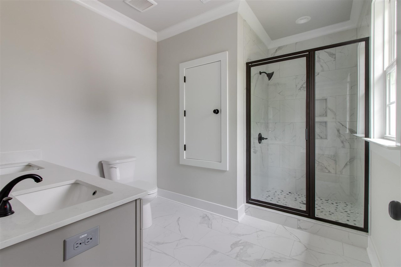 2929 Chapel Hill Road Durham, NC 27707 - Photo 18 of 25 a bathroom with a sink and mirror