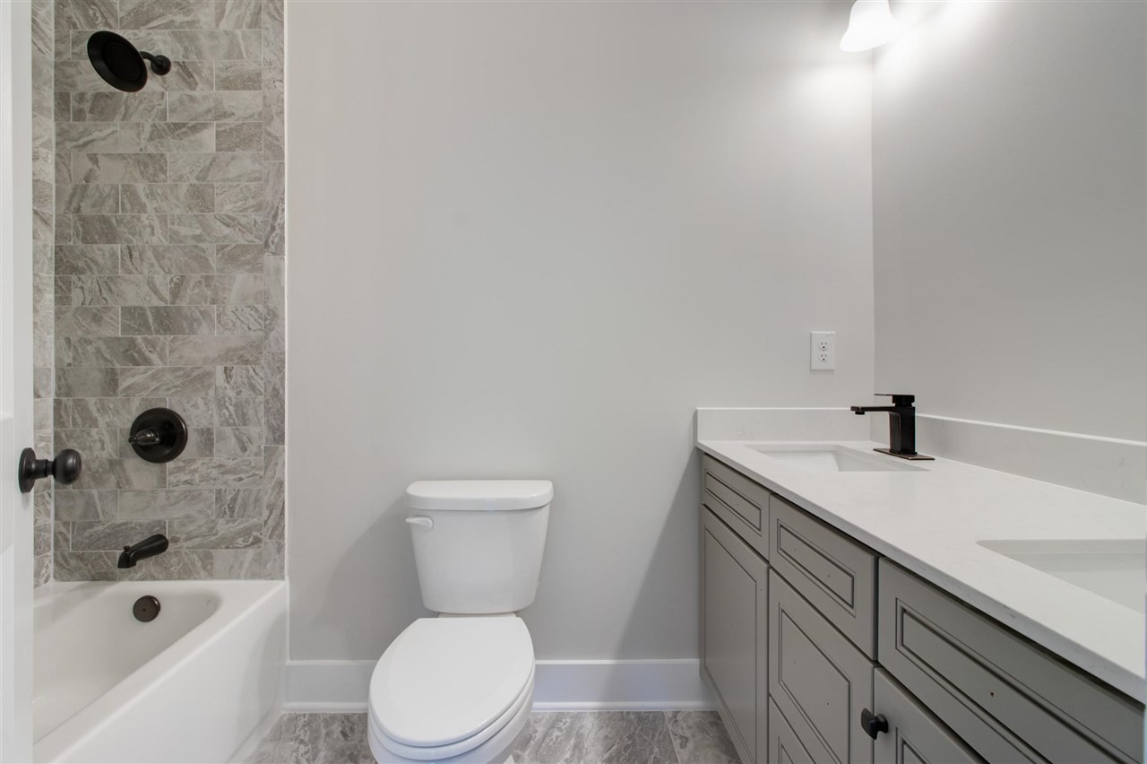 2929 Chapel Hill Road Durham, NC 27707 - Photo 22 of 25 a bathroom with a sink a toilet and shower