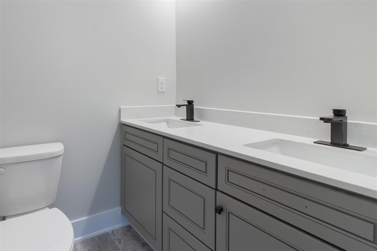 2929 Chapel Hill Road Durham, NC 27707 - Photo 23 of 25 a bathroom with a sink a toilet and vanity