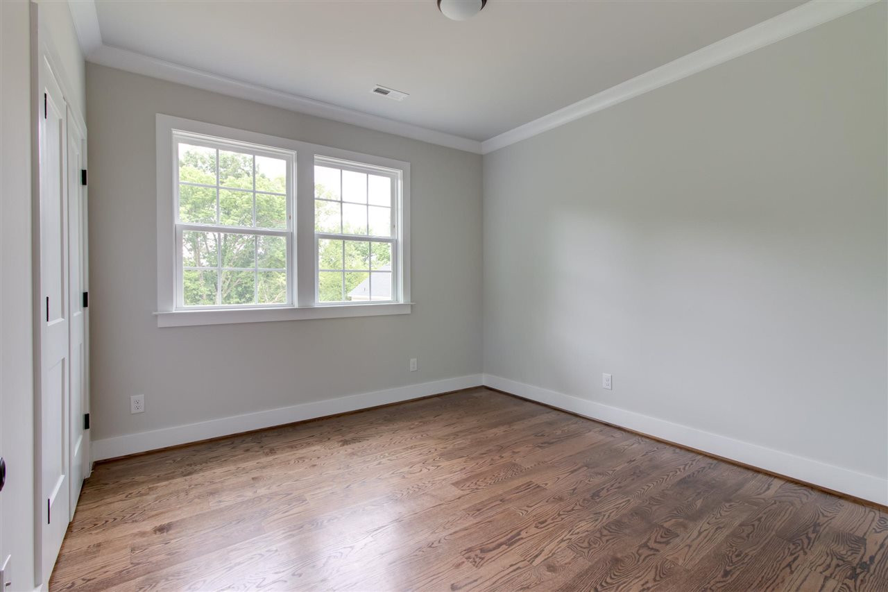 2929 Chapel Hill Road Durham, NC 27707 - Photo 24 of 25 an empty room with wooden floor and windows
