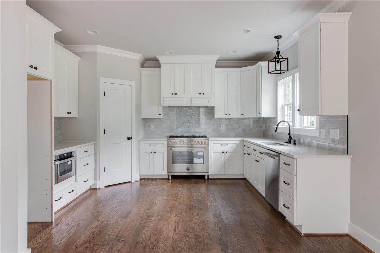 2929 Chapel Hill Road Durham, NC 27707 - Photo 8 of 25 a kitchen with granite countertop white cabinets and white appliances