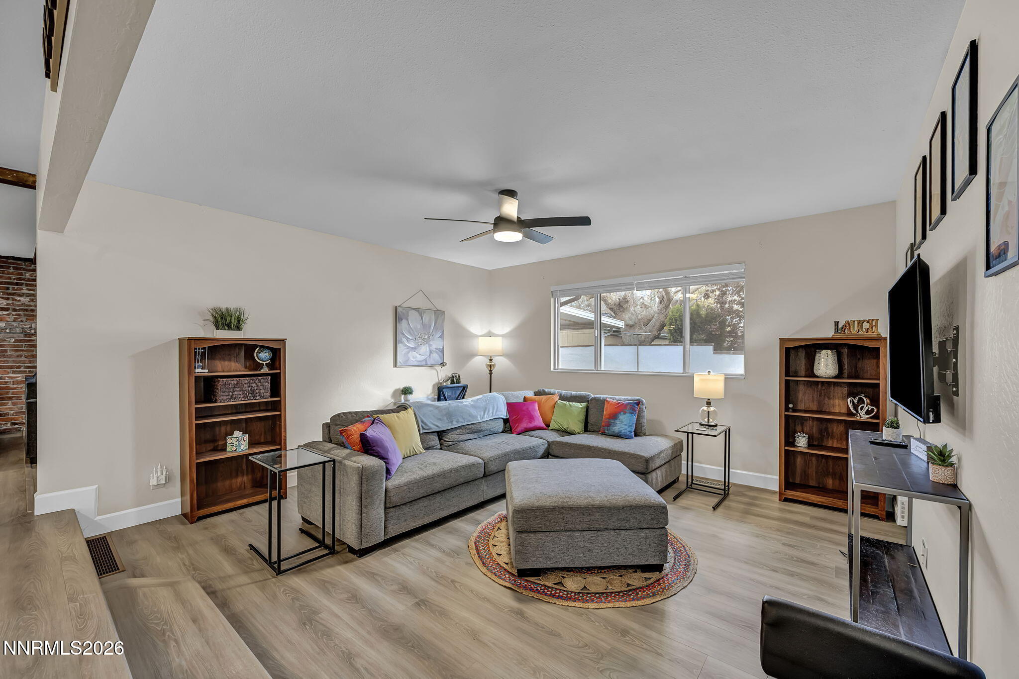 1490 Foster Drive Reno, NV 89509 - Photo 11 of 53 a living room with furniture a flat screen tv and a large window