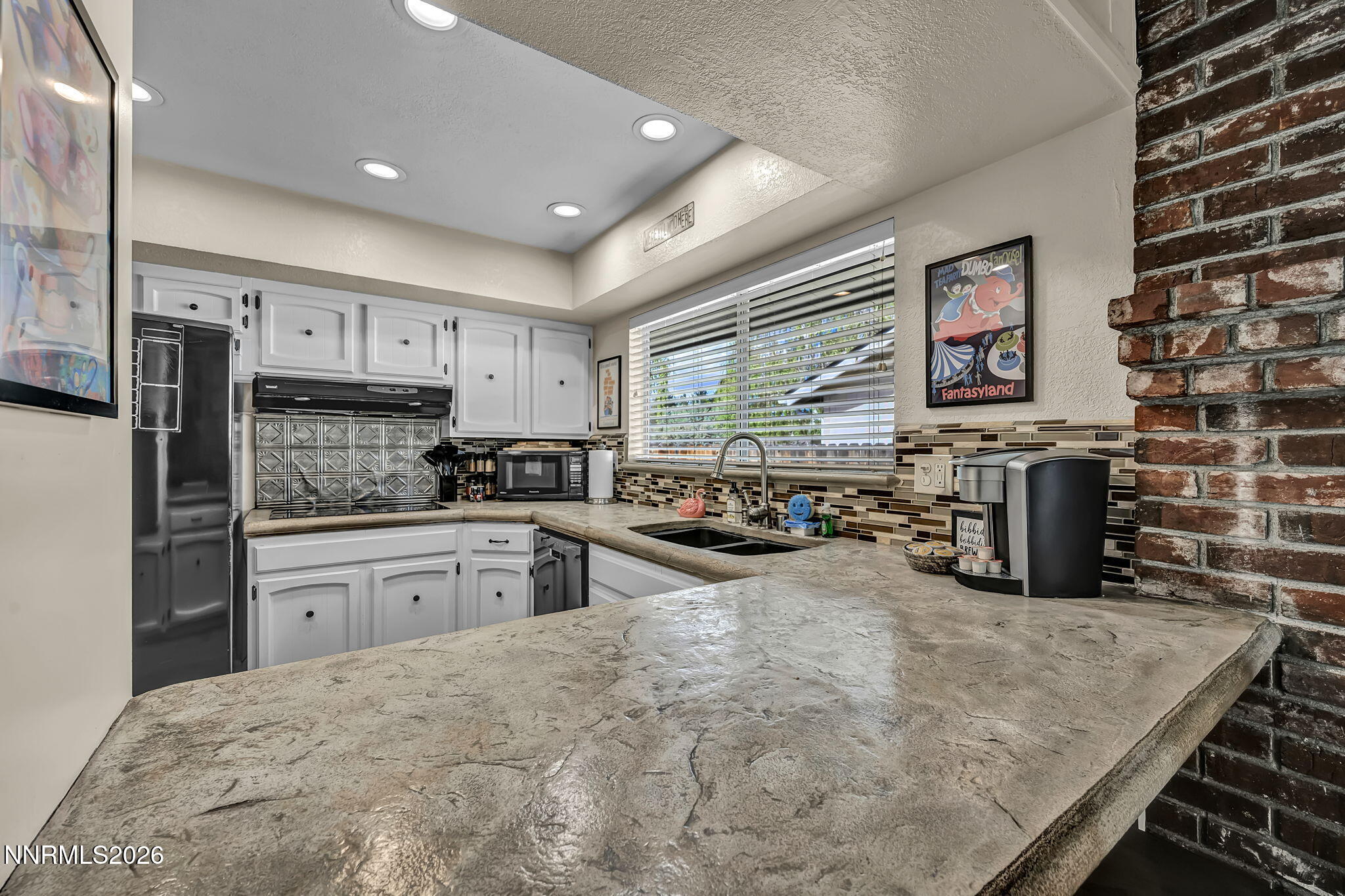1490 Foster Drive Reno, NV 89509 - Photo 17 of 53 a kitchen with stainless steel appliances granite countertop a stove and a refrigerator