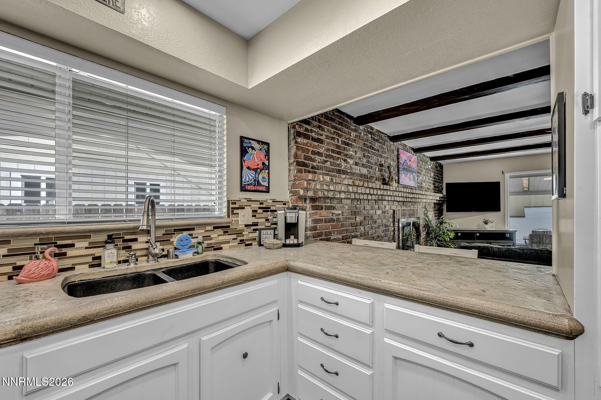 1490 Foster Drive Reno, NV 89509 - Photo 18 of 53 a kitchen with sink cabinets and flat screen tv