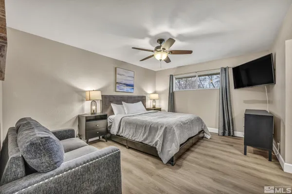 a bedroom with a large bed and a fireplace