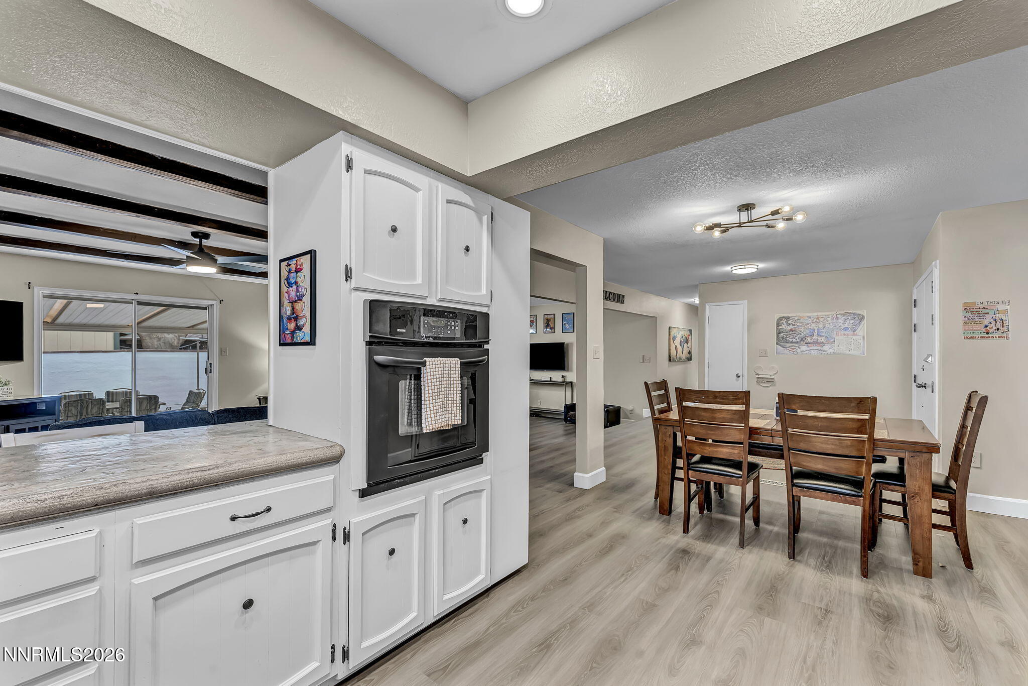 1490 Foster Drive Reno, NV 89509 - Photo 21 of 53 a kitchen with stainless steel appliances kitchen island granite countertop a table chairs sink and cabinets