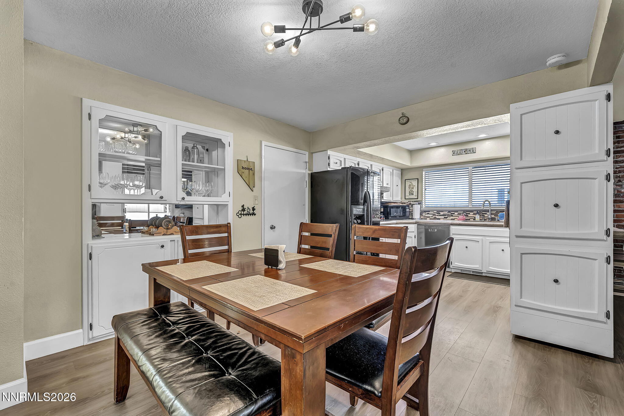 1490 Foster Drive Reno, NV 89509 - Photo 23 of 53 a kitchen with a dining table chairs and white appliances