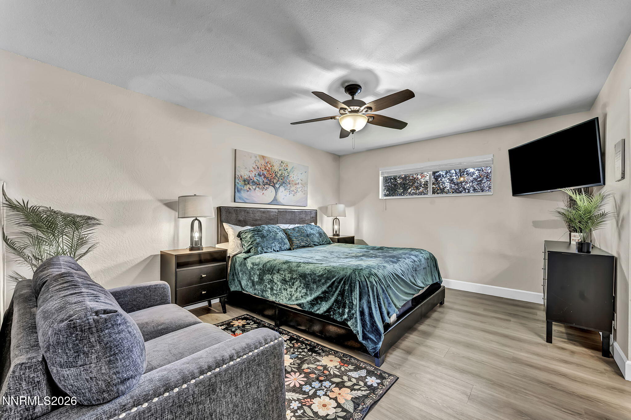 1490 Foster Drive Reno, NV 89509 - Photo 26 of 53 a spacious bedroom with a bed and a flat screen tv