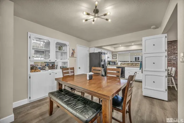 a dining room with furniture and wooden floor