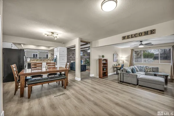 a living room with furniture a ceiling fan and a wooden floor