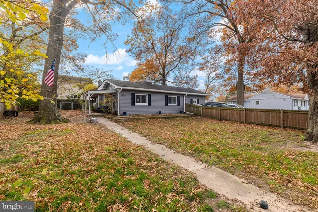 a front view of house with yard and trees around