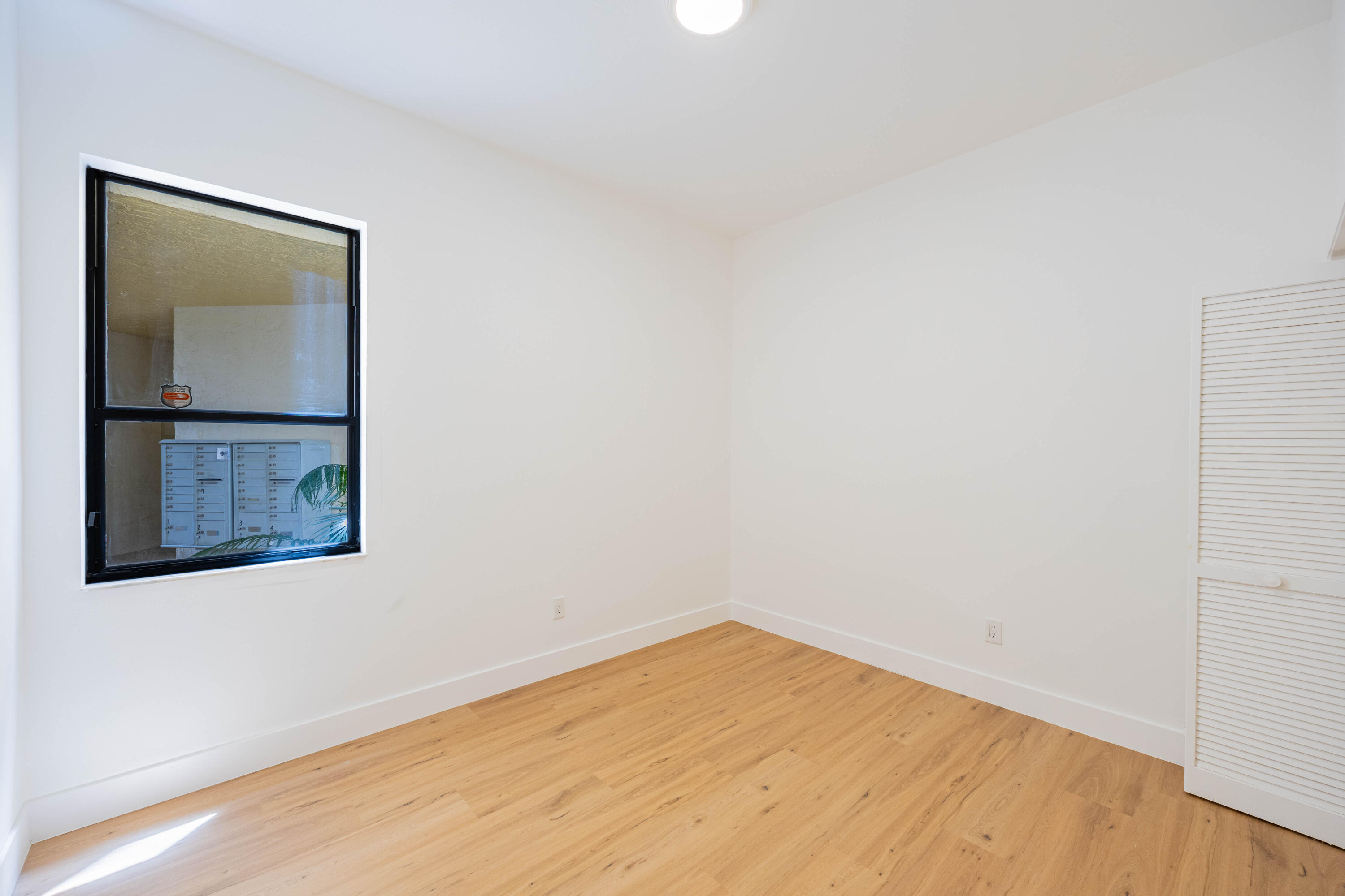7520 La Paz Boulevard, Unit 104 Boca Raton, FL 33433 - Photo 32 of 56 a view of empty room with wooden floor