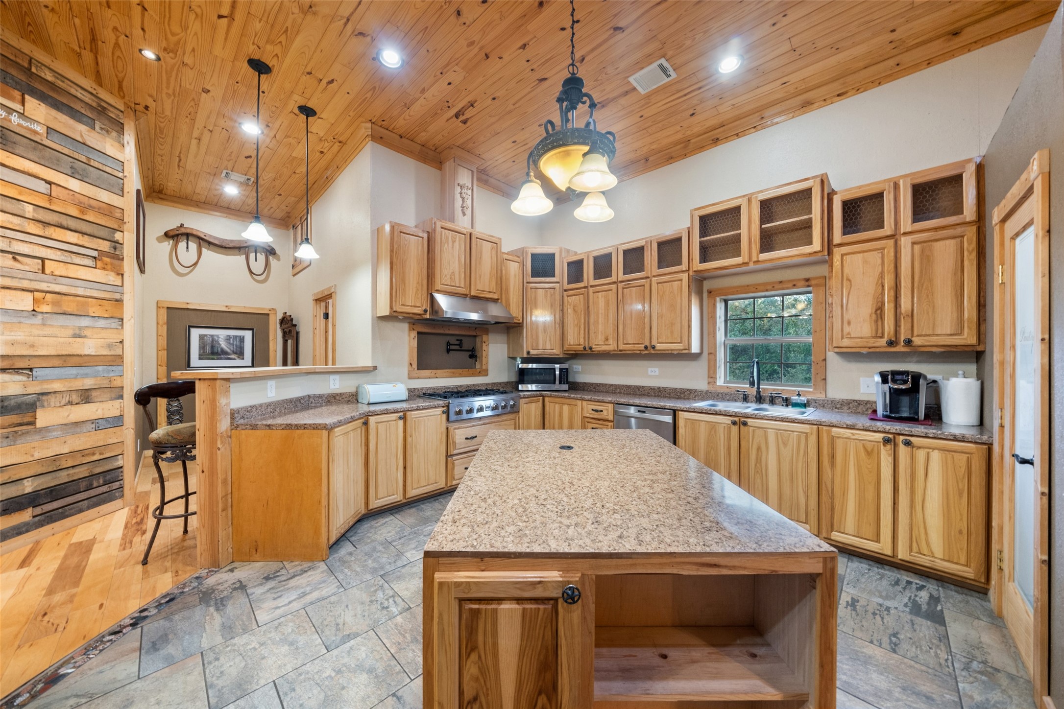 6950 Fm 945 Street North Coldspring, TX 77331 - Photo 12 of 29 a kitchen with stainless steel appliances granite countertop a kitchen island a stove and a sink