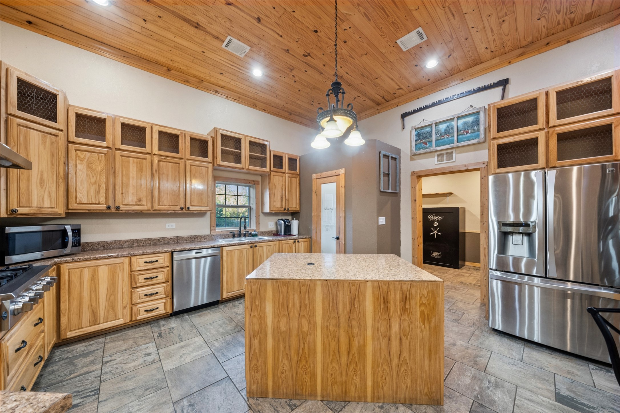 6950 Fm 945 Street North Coldspring, TX 77331 - Photo 13 of 29 a large kitchen with stainless steel appliances kitchen island granite countertop a sink and cabinets