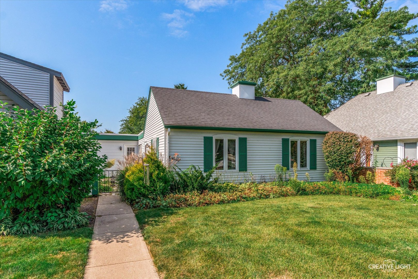 a front view of house with yard and green space