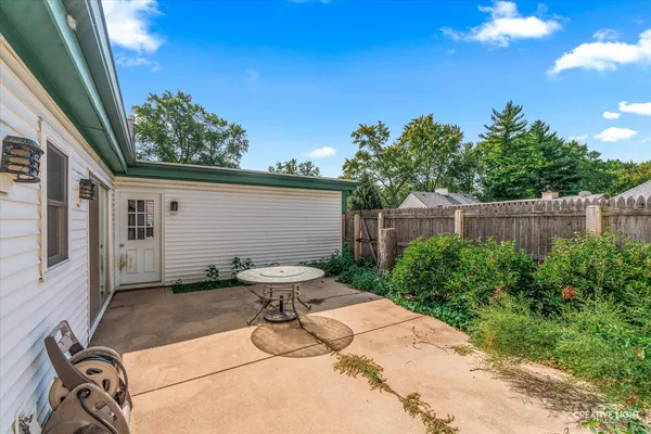 a view of a backyard with sitting area
