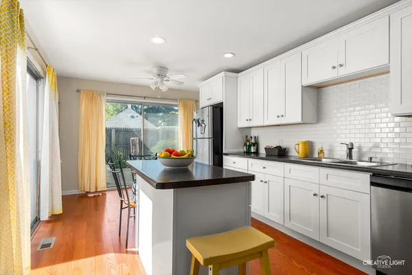 a kitchen with stainless steel appliances granite countertop a sink a stove and a refrigerator
