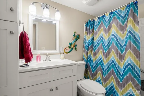 a bathroom with a sink toilet and shower