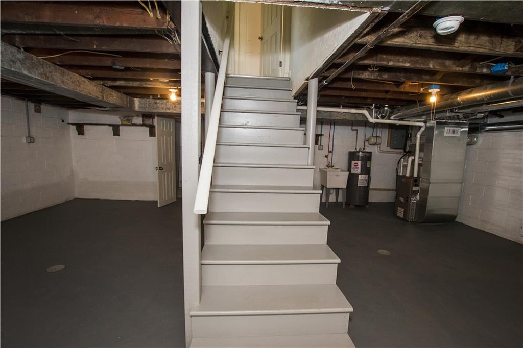 1508 Nine Eighty Road Canonsburg, PA 15317 - Photo 17 of 19 The basement is large and can be finished to add to your living space or used as storage. The laundry is located to the right and connects to the garage.