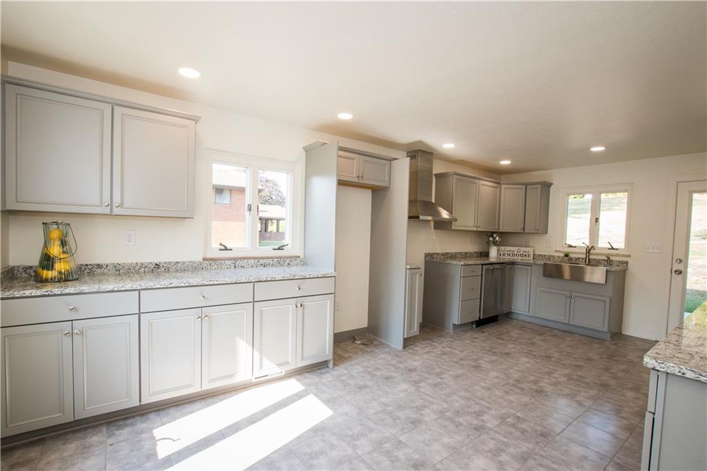 20x12 Your dream Kitchen.  A stainless steel apron sink, hood, dishwasher and granite counter tops.  Room to add a breakfast table or island, also.  Access to the back patio for cookouts or to let the dog out.