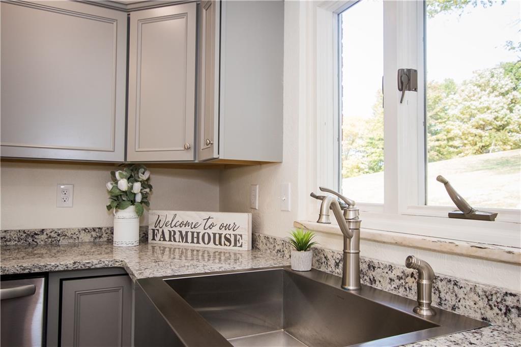 The beauty shines bright....stainless steel apron sink and granite counter tops.  A great view of the back yard as well.