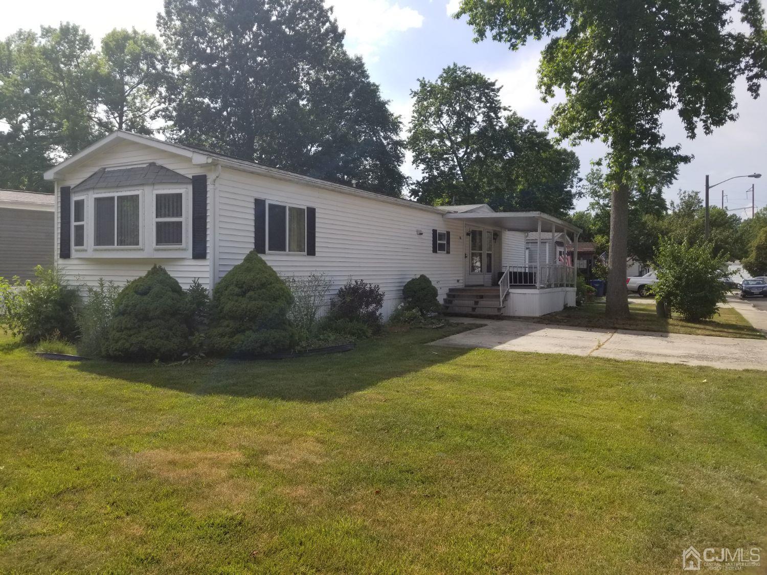 39 Emerson Road North Brunswick, NJ 08902 - Photo 1 of 23 a view of a yard in front of a house with large trees